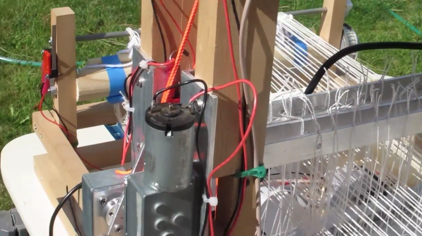  Each 12V motor moves an actuator arm with a cord attached via a pulley to a loom harness